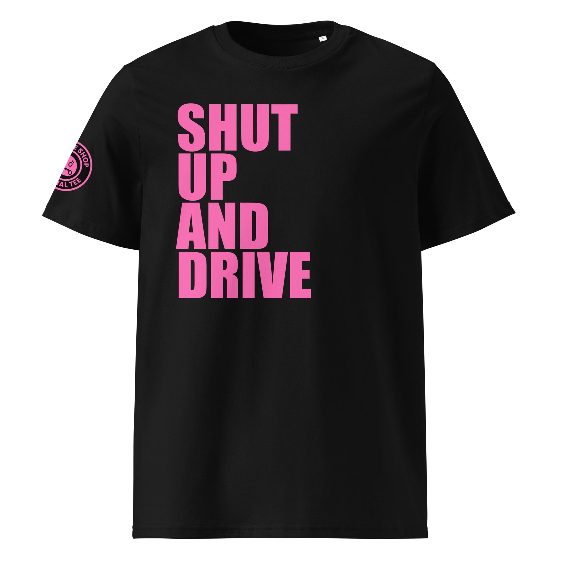 Front view of black unisex t-shirt with bold pink “SHUT UP AND DRIVE” slogan in large font across the chest. DTF print, perfect for car meet fans and driving enthusiasts.
