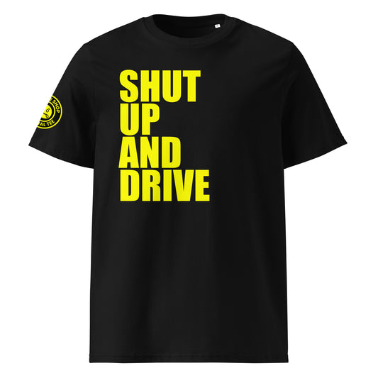 Front view of black unisex t-shirt with bold yellow “SHUT UP AND DRIVE” slogan in large font across the chest. DTF print, perfect for car meet fans and driving enthusiasts.
