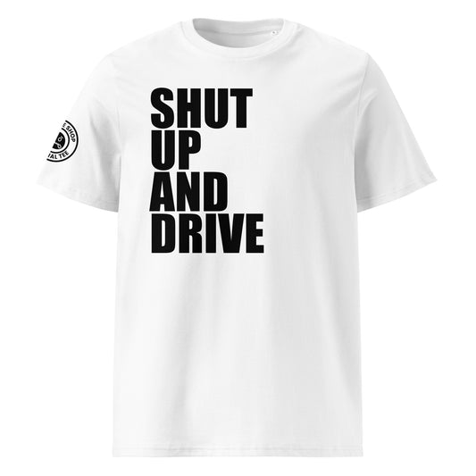 Front view of white unisex t-shirt with bold black “SHUT UP AND DRIVE” slogan in large font across the chest. DTF print, perfect for car meet fans and driving enthusiasts.