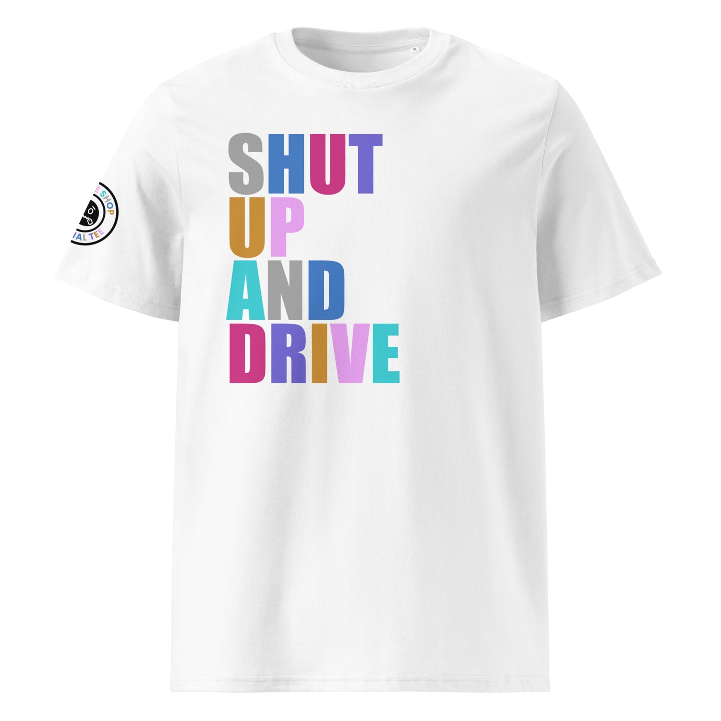 Front view of white unisex t-shirt with “SHUT UP AND DRIVE” slogan in multi-colour harlequin print across the chest. DTF print, perfect for car meet fans and driving enthusiasts.
