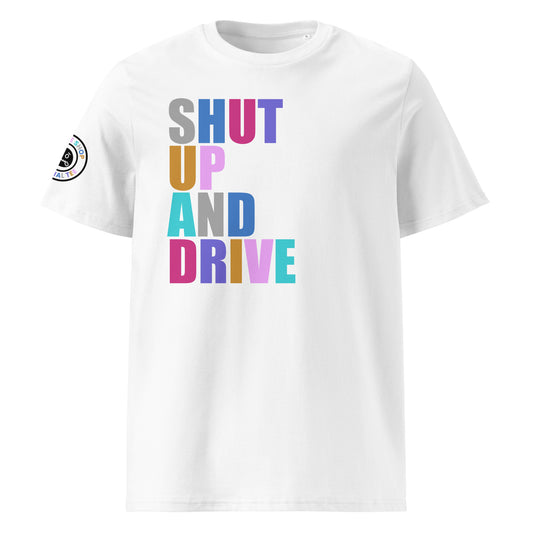 Front view of white unisex t-shirt with “SHUT UP AND DRIVE” slogan in multi-colour harlequin print across the chest. DTF print, perfect for car meet fans and driving enthusiasts.

