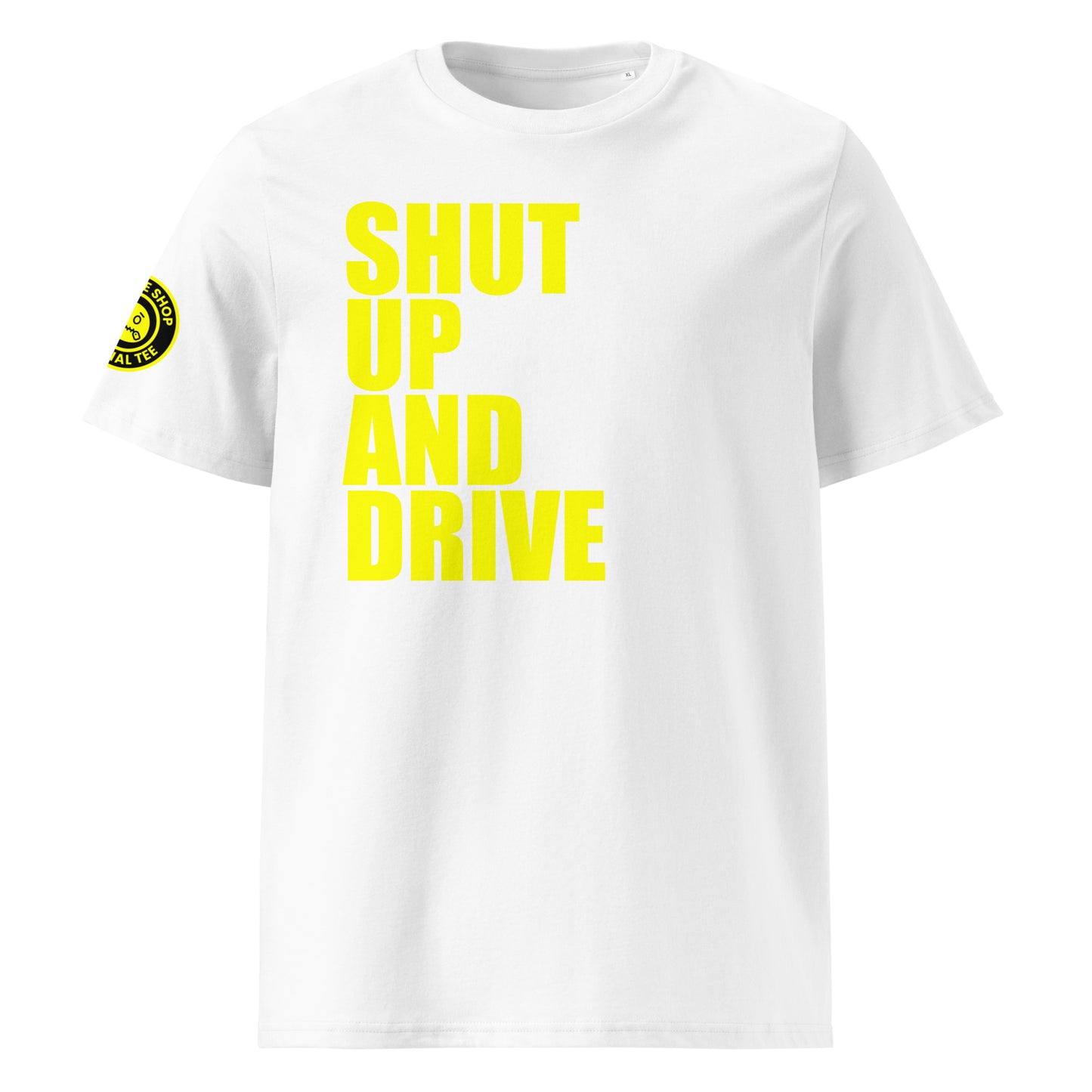 Front view of white unisex t-shirt with bold yellow “SHUT UP AND DRIVE” slogan in large font across the chest. DTF print, perfect for car meet fans and driving enthusiasts.