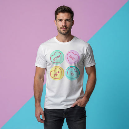 Male model in a white rugby love hearts t‑shirt styled casually for summer, featuring Scrum, Maul, Ruck, Try heart print