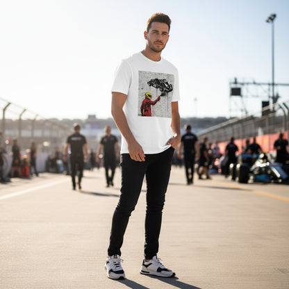 Man wearing TheTeeShop’s Scuderia Series Prancing Horse Graffiti T-Shirt, standing trackside at a Formula 1 paddock with team members and race cars in the background, showcasing bold Ferrari-inspired streetwear.
