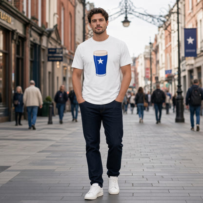 Full-length photo of a male model wearing a white St Mary’s College Mega Pint rugby t-shirt with a blue pint glass and white star graphic, walking on a town street for match day fanwear