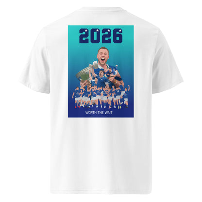 White unisex organic cotton t-shirt with a small blue star on the front chest and a large “2026” St Marys rugby celebration graphic on the back with the text “WORTH THE WAIT”.