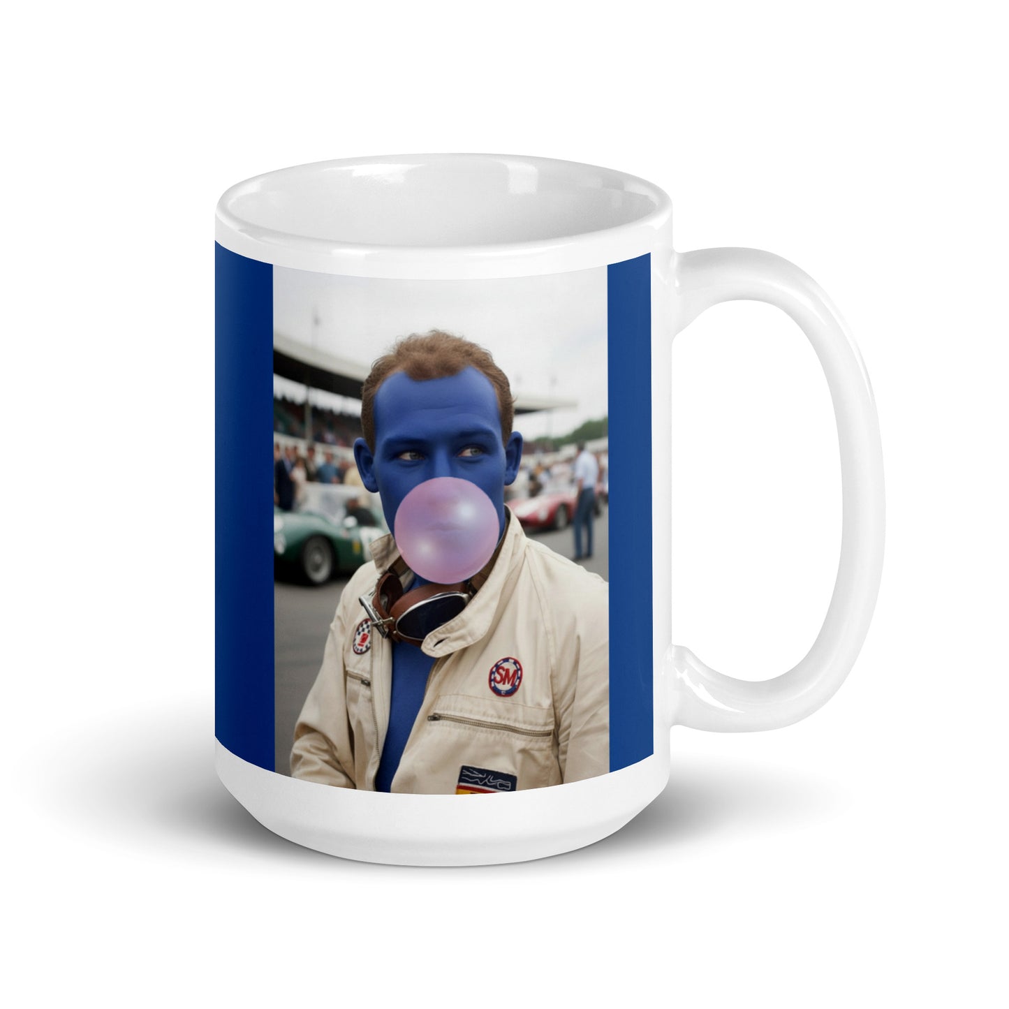 White ceramic 15oz mug with a bold blue border featuring a pop-art style portrait of Stirling Moss in a white racing suit, blue-tinted face, and blowing a pink bubblegum bubble, with a vintage racetrack scene in the background.
