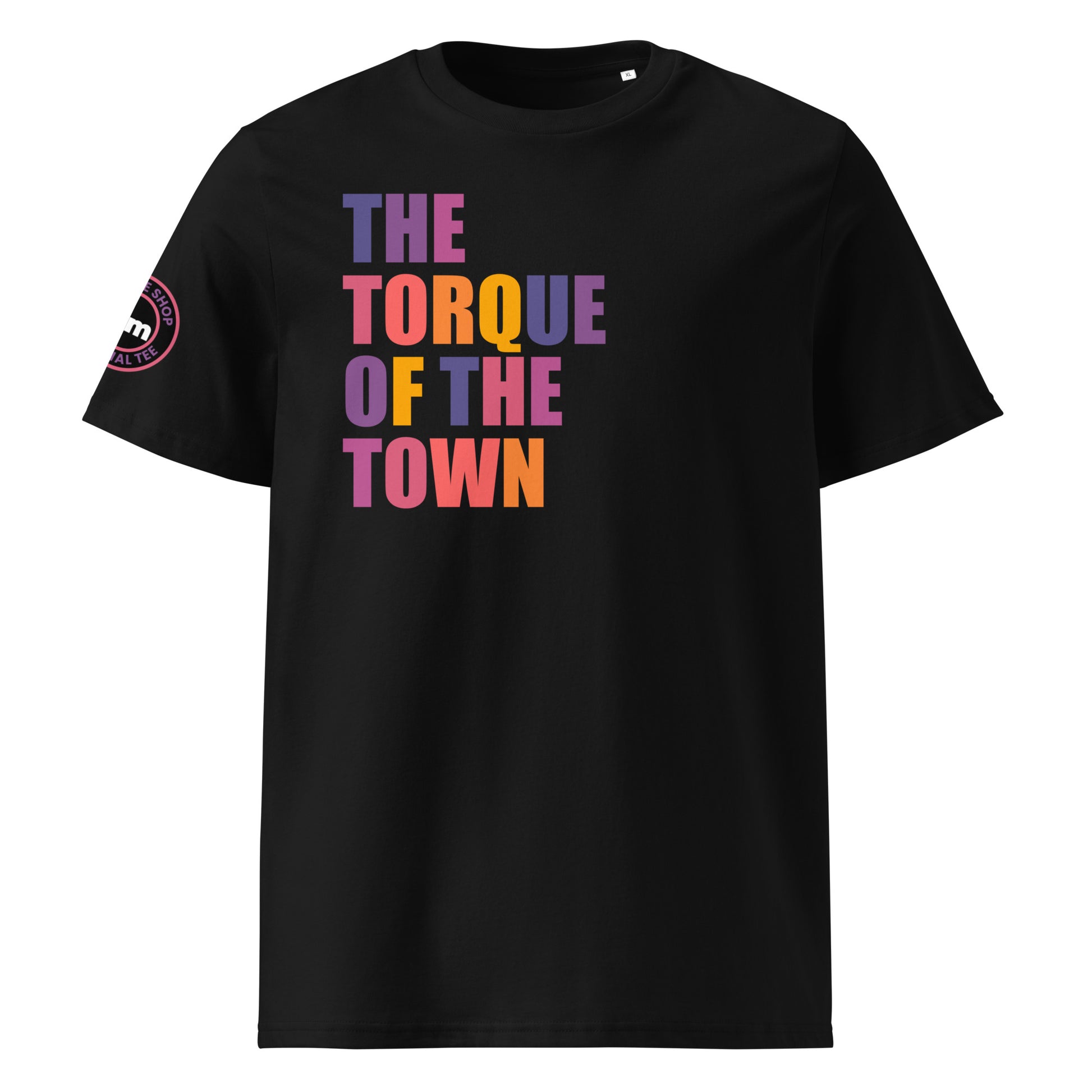 Front view of black unisex t-shirt with “THE TORQUE OF THE TOWN” slogan in multi-colour harlequin print. DTF print, perfect for car meets, torque fans, and petrolhead banter.