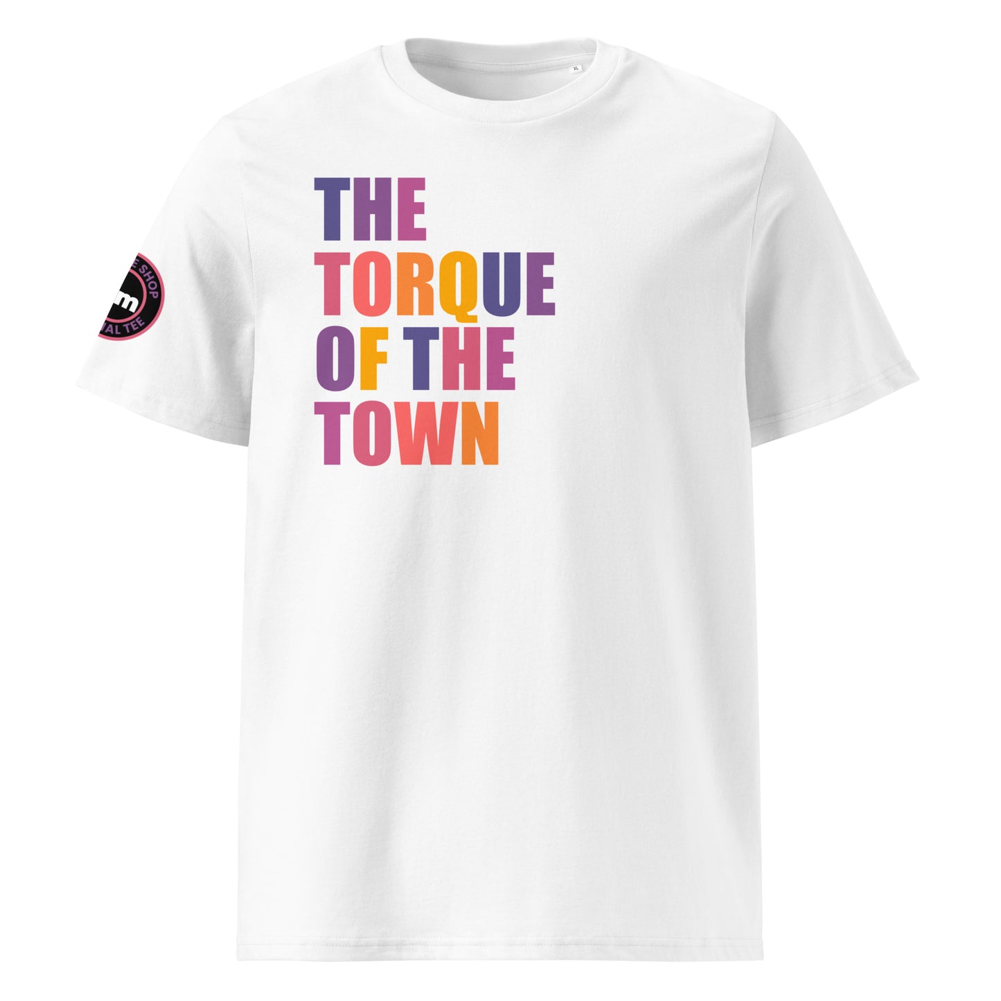 Front view of white unisex t-shirt with “THE TORQUE OF THE TOWN” slogan in multi-colour harlequin print. DTF print, perfect for car meets, torque fans, and petrolhead banter.