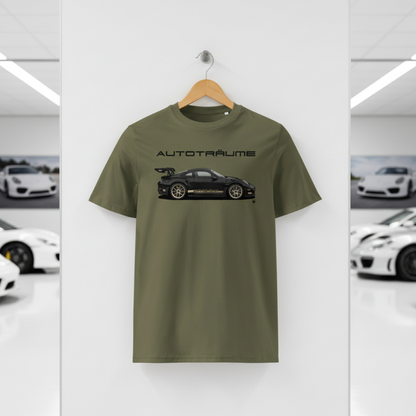 Khaki AUTOTRÄUME GT3 T‑shirt with a black Porsche‑style car and gold highlights illustration hanging on a premium wooden hanger and silver wall peg against a central white wall in a bright sports car gallery, with a glossy white floor and blurred white and silver sports cars running down both sides.