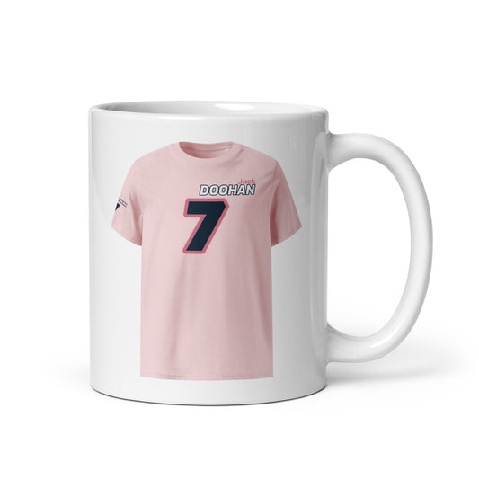 A white ceramic TeeMug© featuring an Alpine pink and blue design with "DOOHAN" in bold letters and the number "7". The mug is held by a handle on the right side.