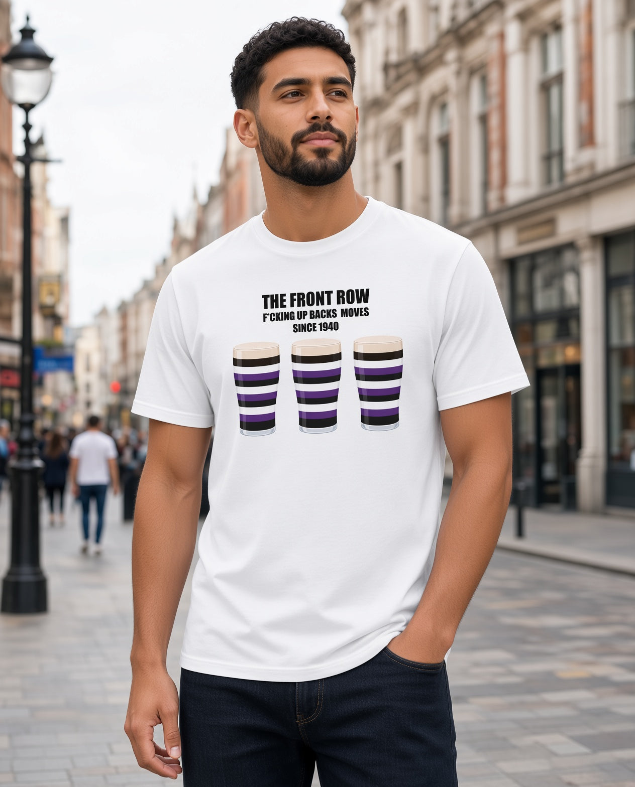 Male model wearing a white Terenure rugby t-shirt reading “The Front Row -F*cking Up Back Moves Since 1940” with three purple, black and white pint graphics, photographed outdoors in Grafton Street Dublin
