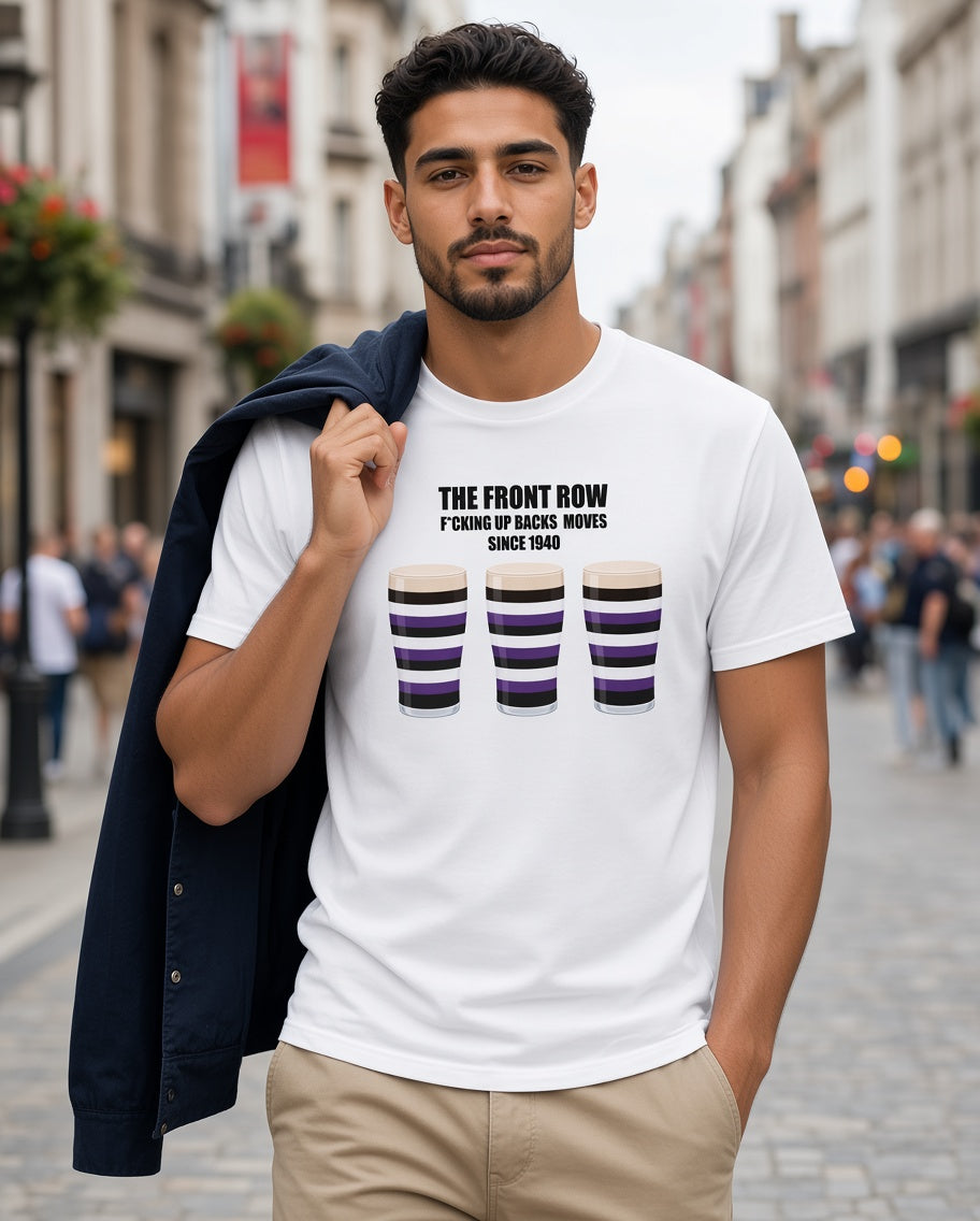Male model wearing a white Terenure rugby t-shirt reading “The Front Row - F*cking Up Back Moves Since 1940” with three purple, black and white pint graphics, styled with a jacket for trendy rugby supporters