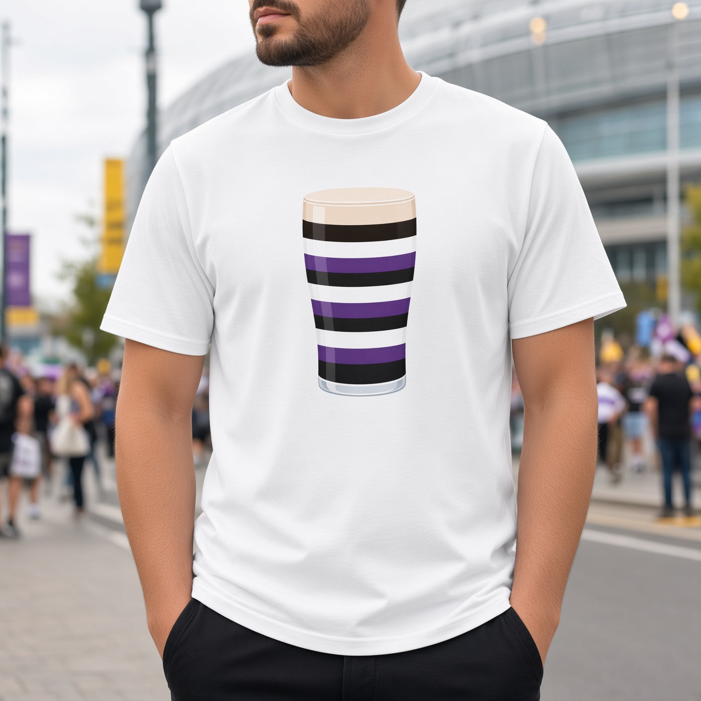 Male model wearing a white Terenure Mega Pint rugby t-shirt with a purple, black and white striped pint glass graphic, photographed in a busy Leinster match day crowd setting.