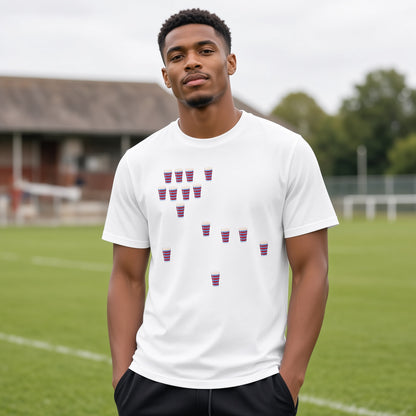 Male model wearing a white vintage Blackheath Team Pints rugby t-shirt with scattered red and light blue striped pint graphics, photographed at a rugby ground for match day supporters in South East London