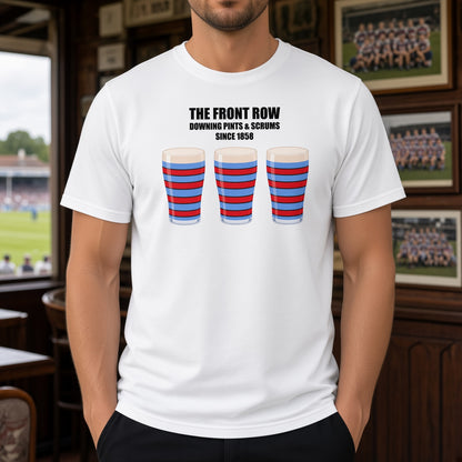 Male model wearing a white vintage Blackheath rugby t-shirt reading “The Front Row – Downing Pints & Scrums Since 1858” with three red and light blue striped pint graphics, photographed inside a rugby clubhouse/pub setting