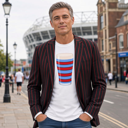 Man wearing a white vintage Blackheath rugby Mega Pint t-shirt with a red and light blue striped pint glass graphic, styled with a blazer for London match days and England rugby supporters