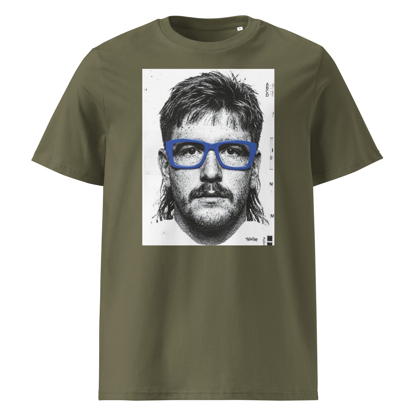 Khaki t-shirt front view featuring an illustrated portrait inspired by a modern rugby lock wearing bold blue glasses with a “what you looking at?” expression