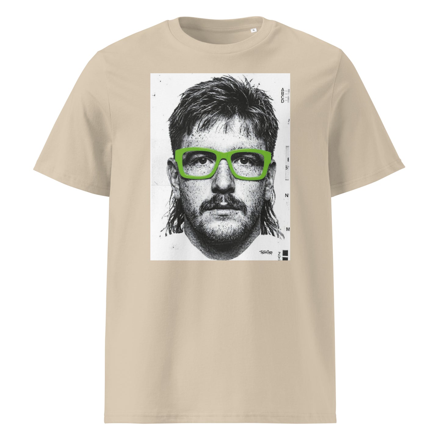 Desert Dust t-shirt front view featuring an illustrated portrait inspired by a modern rugby lock wearing bold green glasses with a “what you looking at?” expression