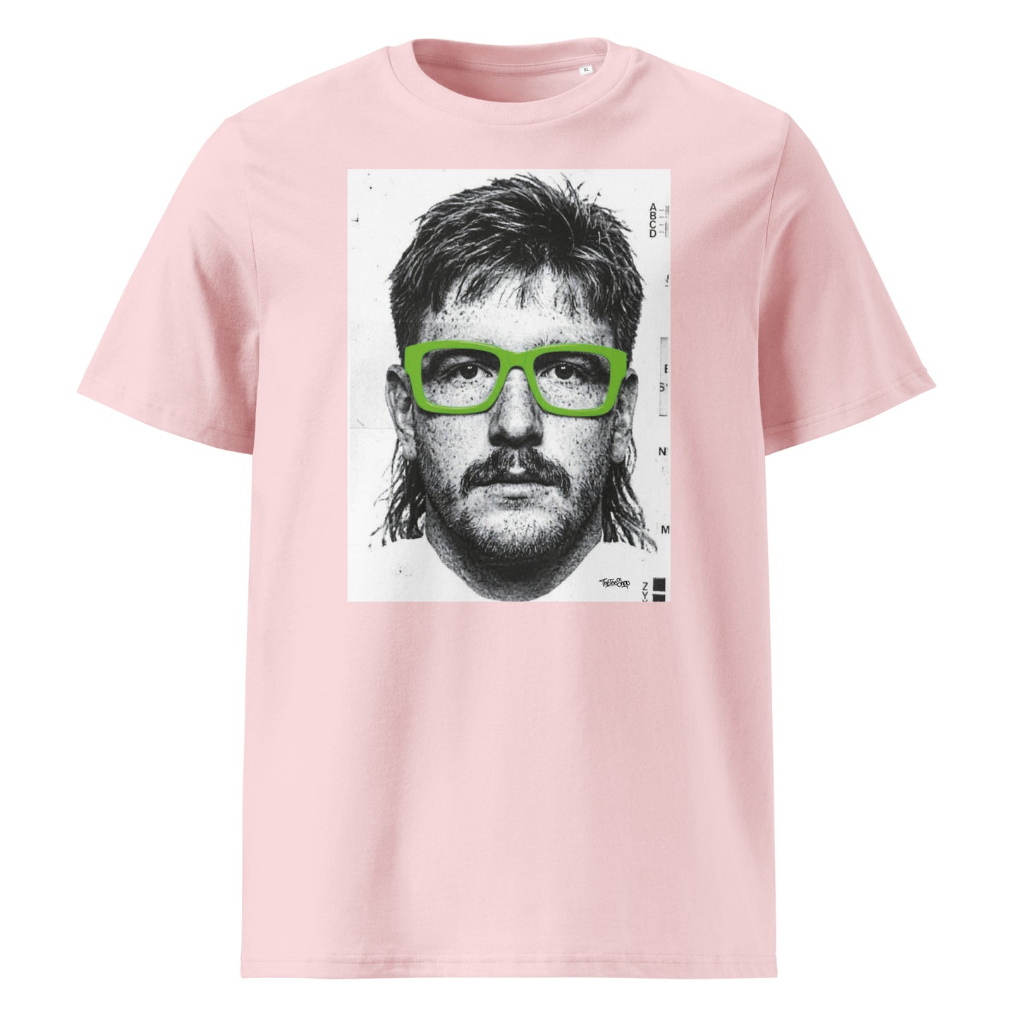 Pink t-shirt front view featuring an illustrated portrait inspired by a modern rugby lock wearing bold green glasses with a “what you looking at?” expression