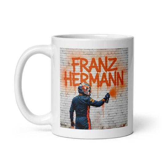 11oz white mug with Franz Hermann displayed in a street art way. Handle on left side