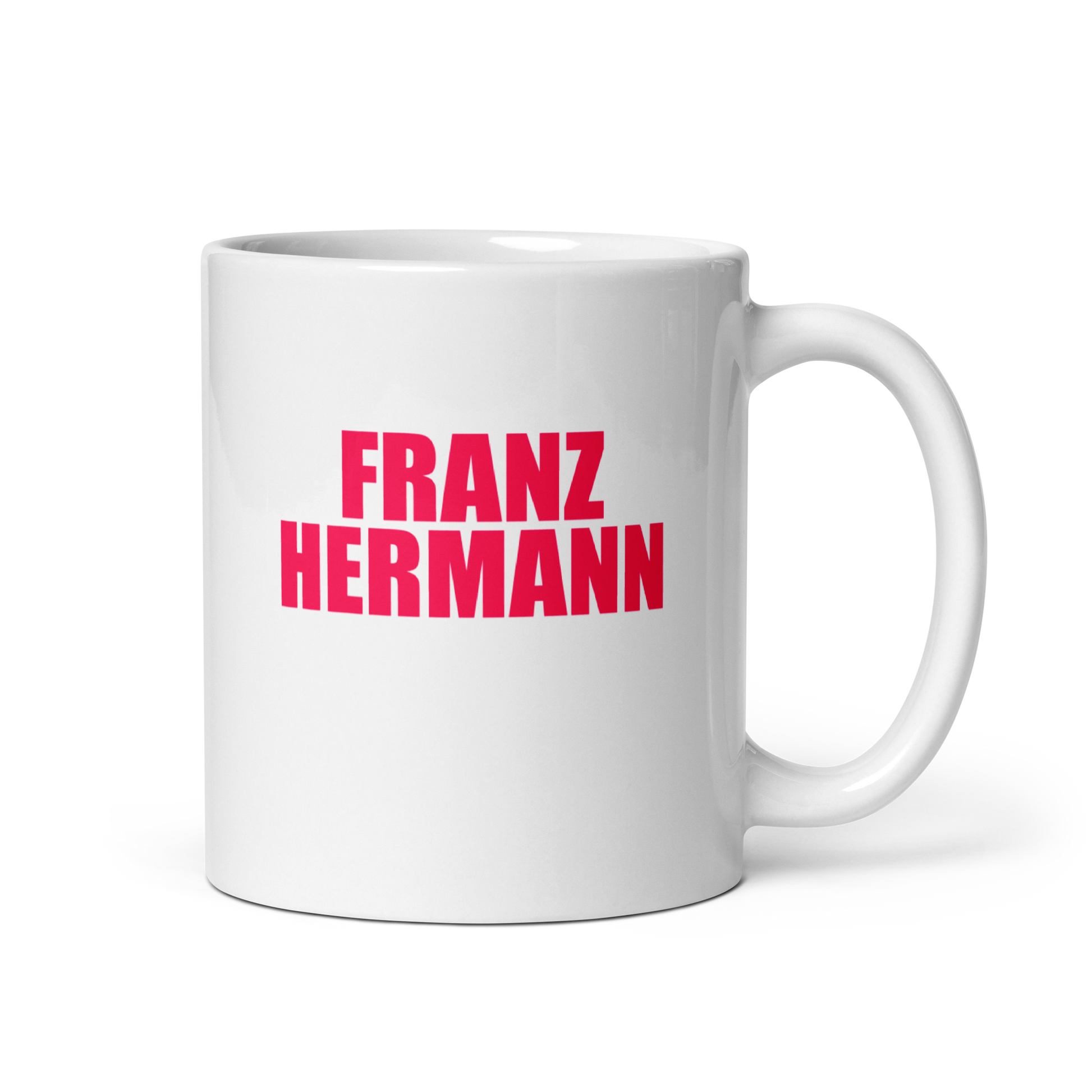 White mug with red bull pink text 'FRANZ HERMANN' on a white background. Handle on right.