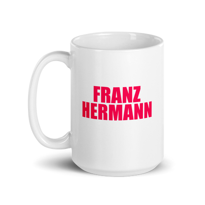 15oz White mug with red bull pink text 'FRANZ HERMANN' on a white background. Handle on left.