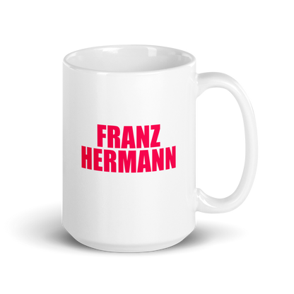 15oz White mug with red bull pink text 'FRANZ HERMANN' on a white background. Handle on right.