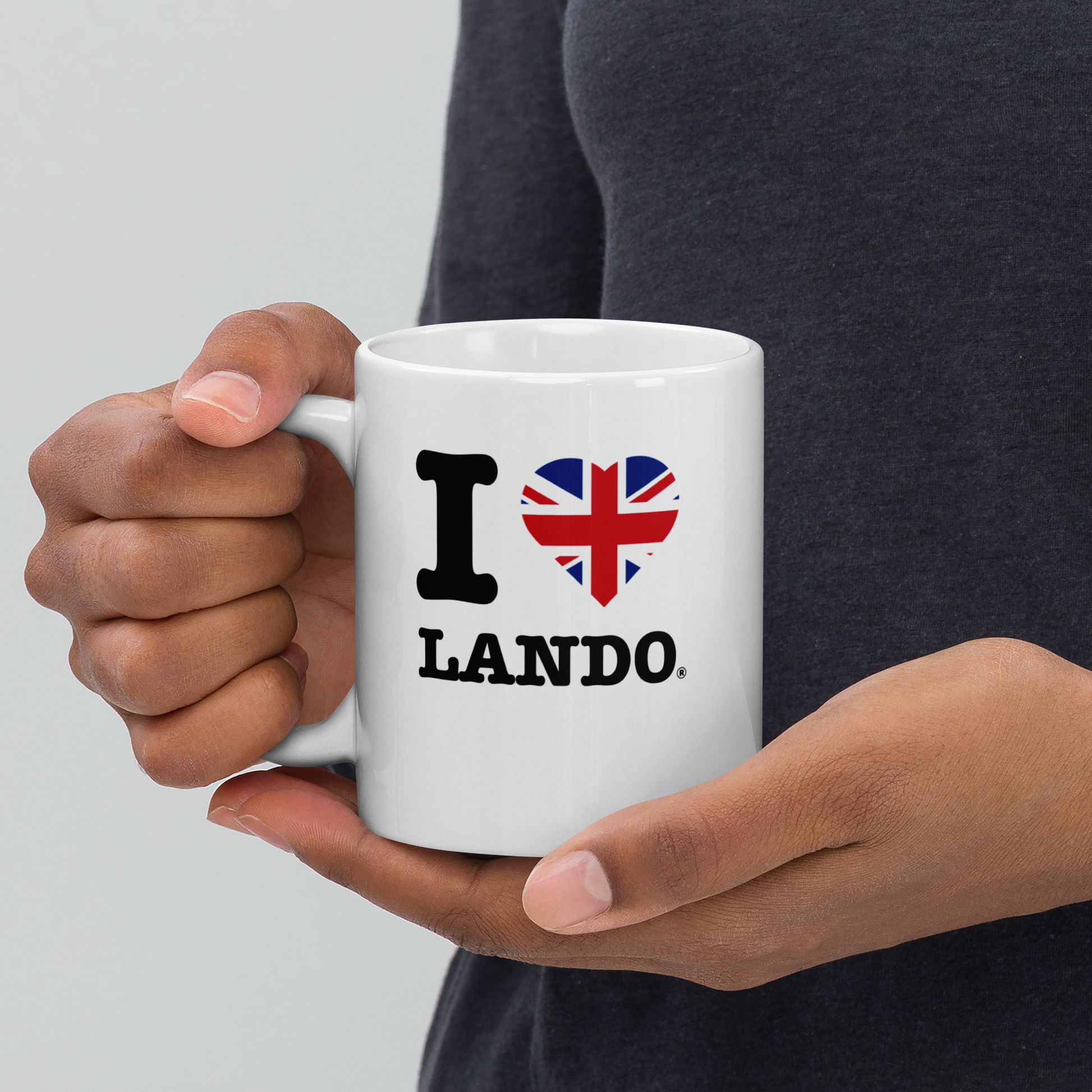 Person holding a white mug with 'I ❤️ Lando' design on a plain background