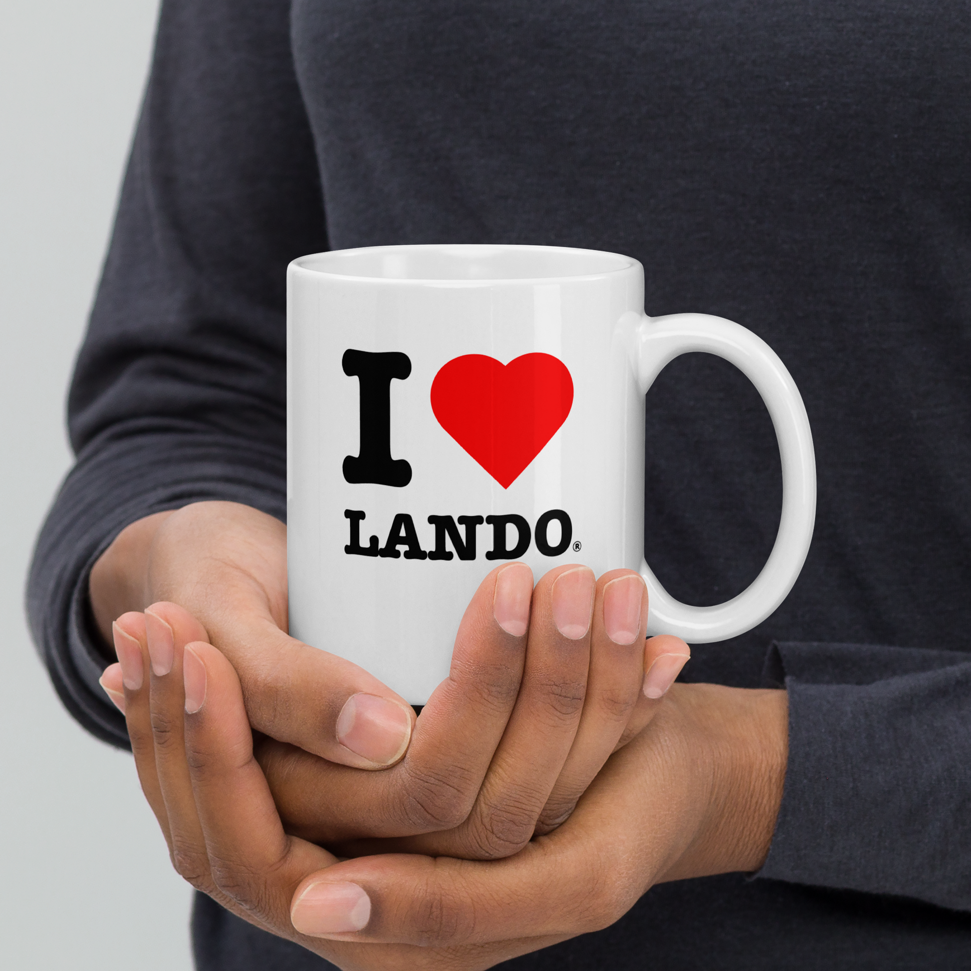 Person holding a white mug with 'I ❤️ Lando' design. Perfect gift for Lando Norris fans.