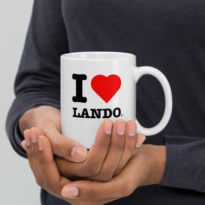 Person holding a white mug with 'I ❤️ Lando' design. Perfect gift for Lando Norris fans.