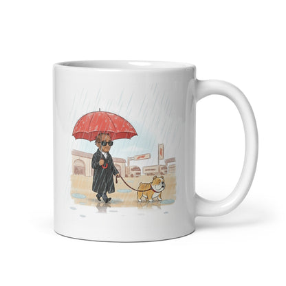 White ceramic 11oz mug with handle on the right hand side with Leiws Hamiltong and Roscoe walking in the rain.
